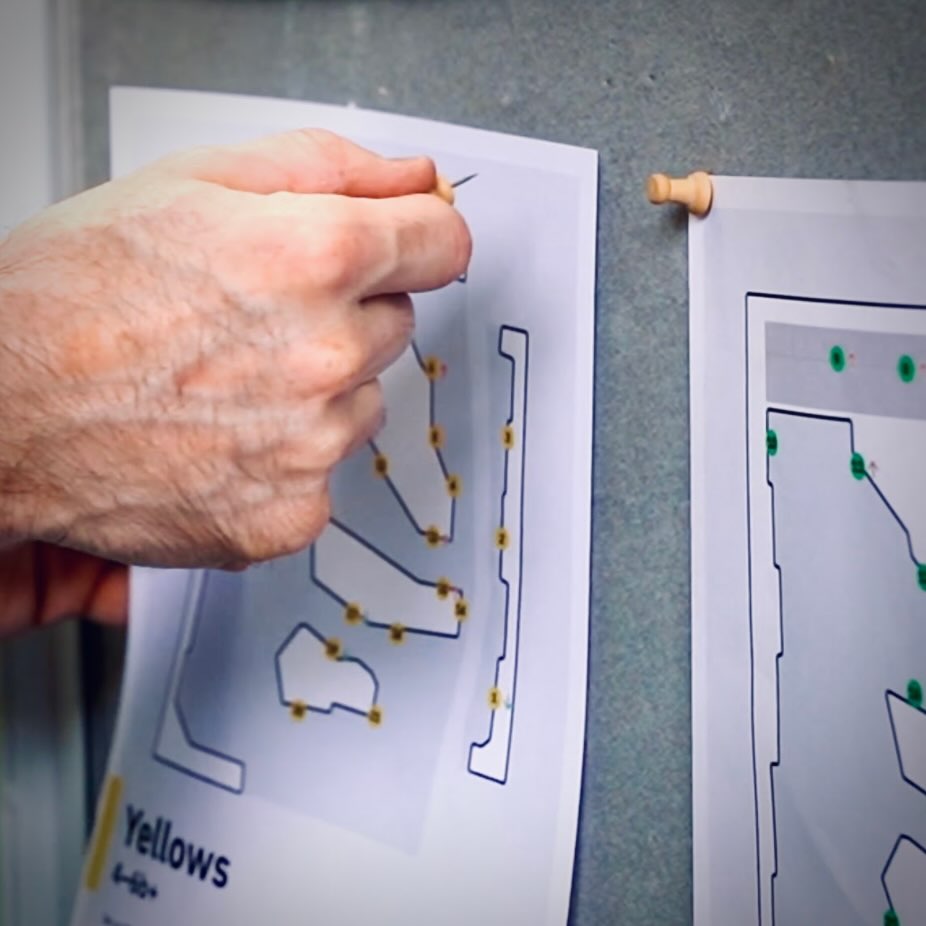 A printed gym map showing freshly set climbs