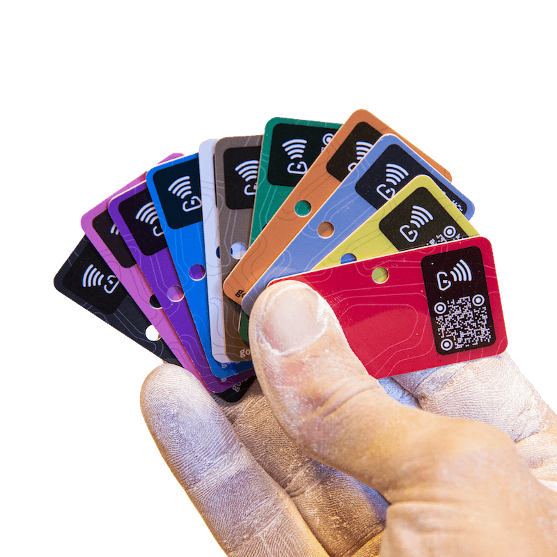 A hand fanning out colourful NFC and QR-enabled Griptonite route tags