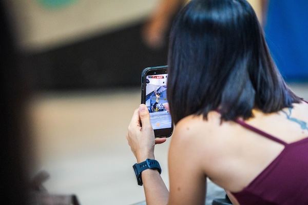 A climber records a video of another climber