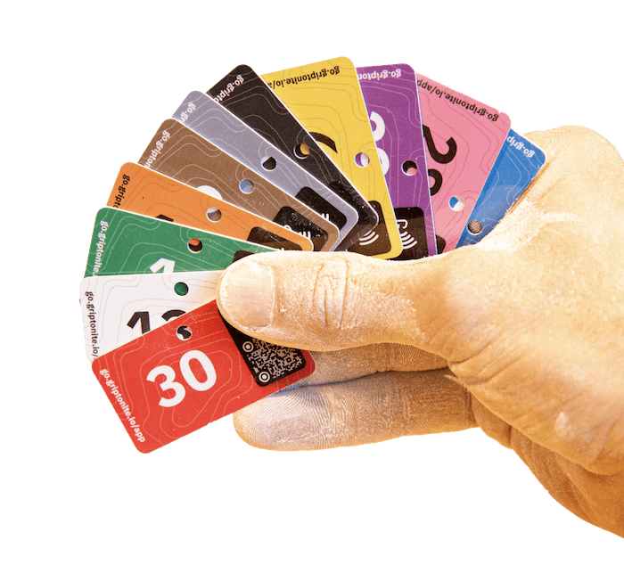 A hand fanning out numbered Griptonite tags in different colours