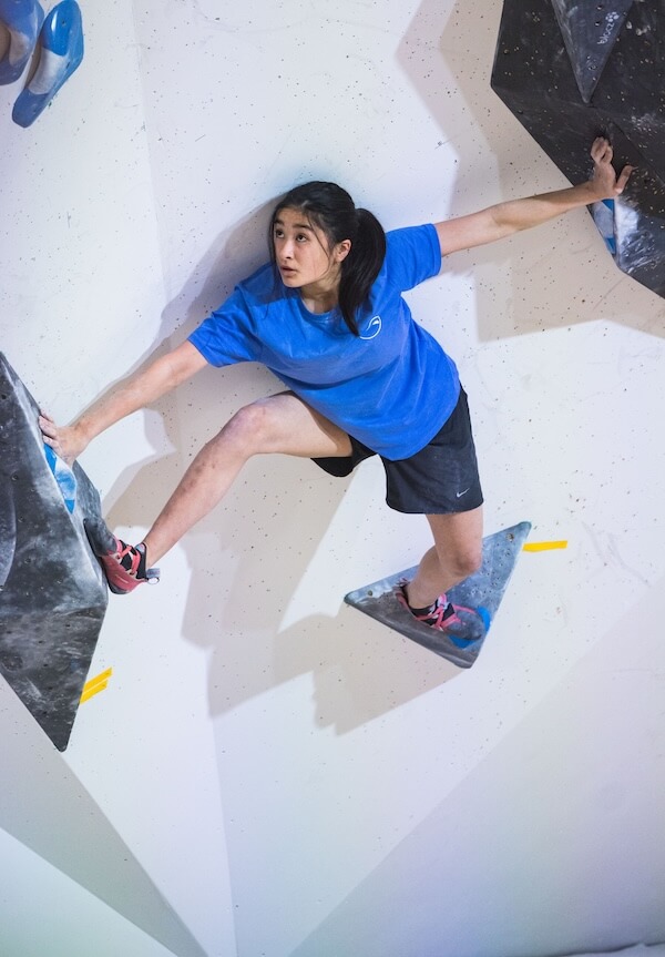 A climber on an indoor bouldering wall