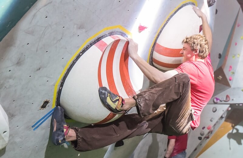 A climber working a route on an indoor wall
