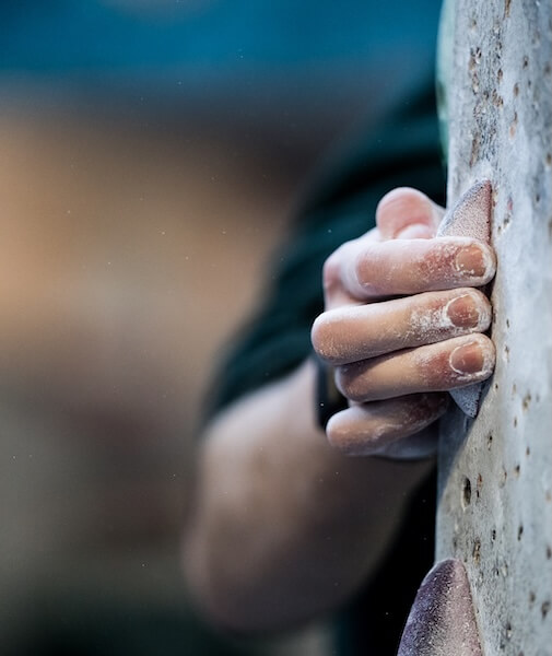 Close-up of a climber's hands on holds
