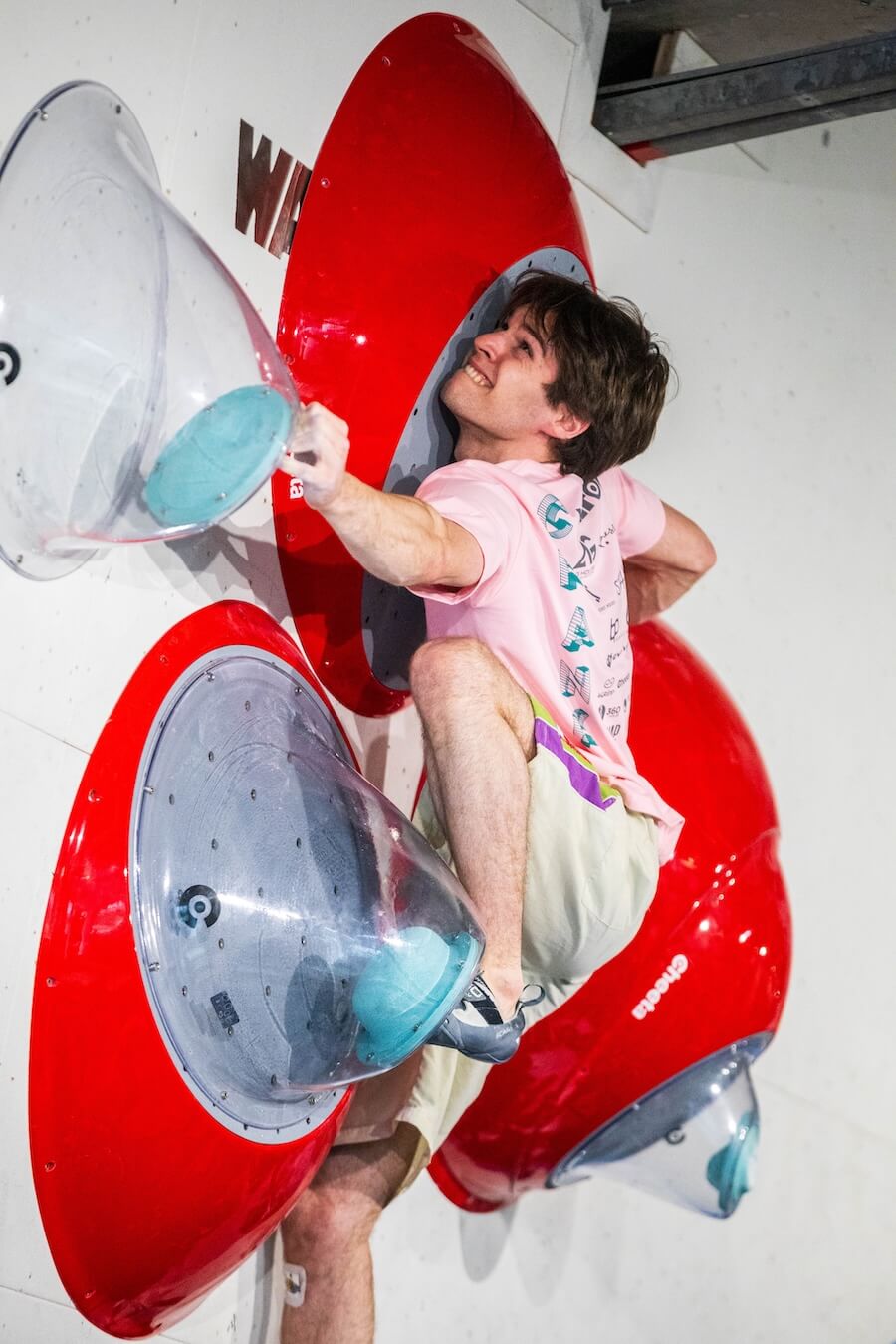 A climber on an indoor bouldering wall