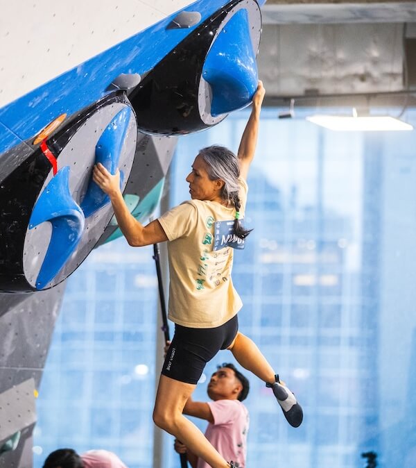A climber on an indoor bouldering wall