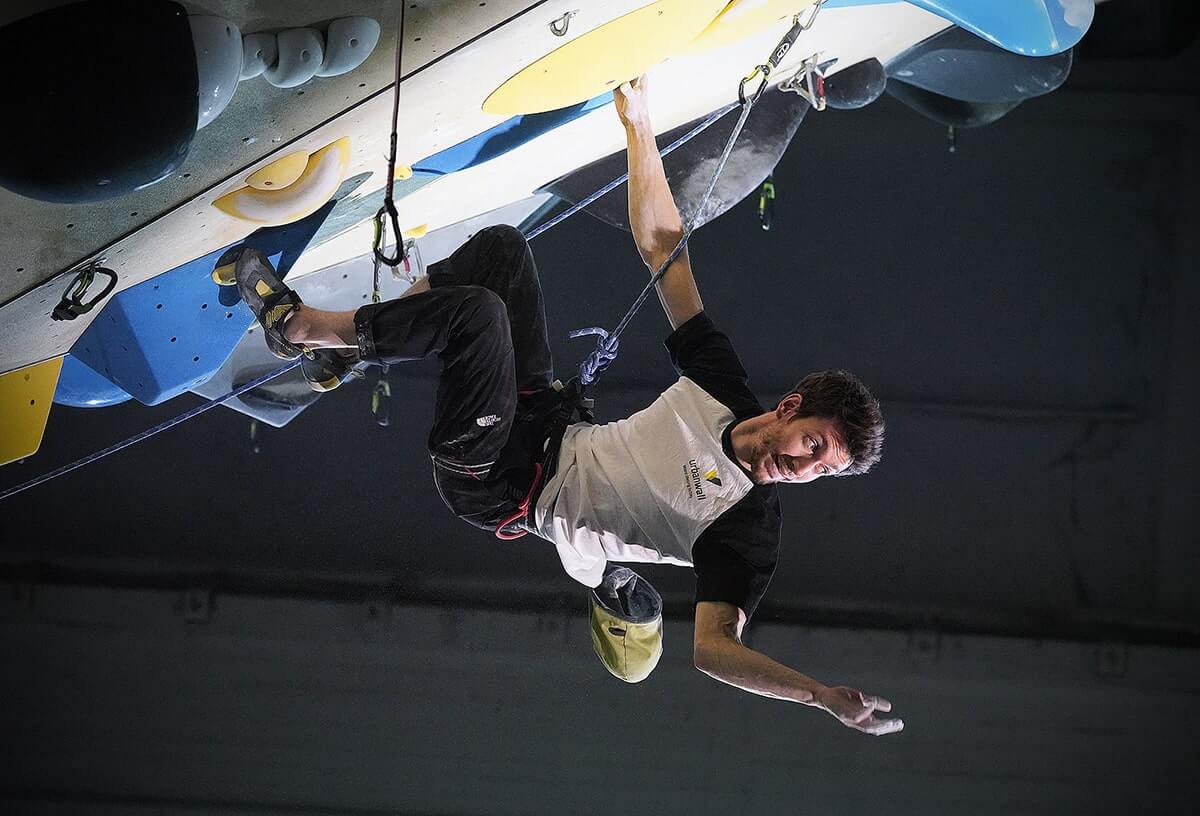 A climber on an indoor bouldering wall